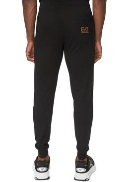 Calça Emporio Armani EA7 preta e dourada para homem.